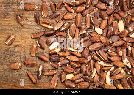 roasted pili nuts, grown in Philippines, against a grunge wood background Stock Photo