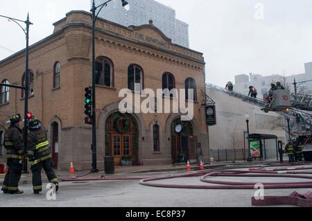 Chicago, USA. 10th Dec, 2014. Firefighters work to extinguish a fire broken out in a restaurant in downtown Chicago, the United States, on Dec.10, 2014.A fire caused by propane tanks accident broke out in downtown Chicago on Wednesday. Credit:  He Xianfeng/Xinhua/Alamy Live News Stock Photo