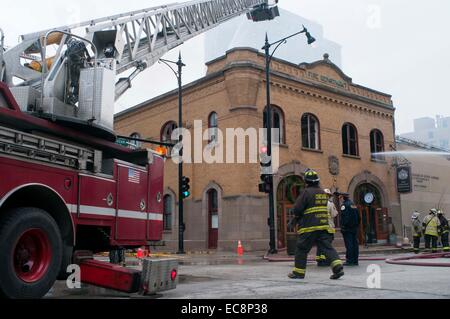 Chicago, USA. 10th Dec, 2014. Firefighters work to extinguish a fire broken out in a restaurant in downtown Chicago, the United States, on Dec.10, 2014. A fire caused by propane tanks accident broke out in downtown Chicago on Wednesday. Credit:  He Xianfeng/Xinhua/Alamy Live News Stock Photo