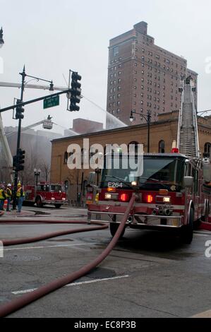 Chicago, USA. 10th Dec, 2014. Firefighters work to extinguish a fire broken out in a restaurant in downtown Chicago, the United States, on Dec.10, 2014.A fire caused by propane tanks accident broke out in downtown Chicago on Wednesday. Credit:  He Xianfeng/Xinhua/Alamy Live News Stock Photo