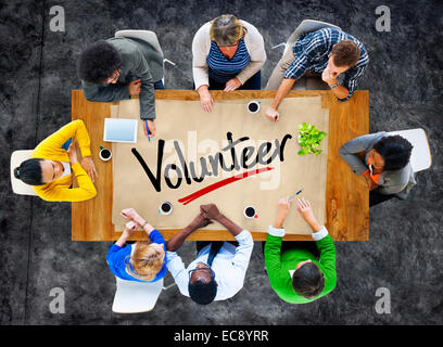 People in a Meeting and Single Word Volunteer Stock Photo