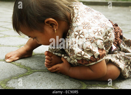 Balinese Little girl in Batur temple playing Stock Photo