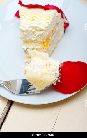 whipped cream mango cake with red rose petals Stock Photo