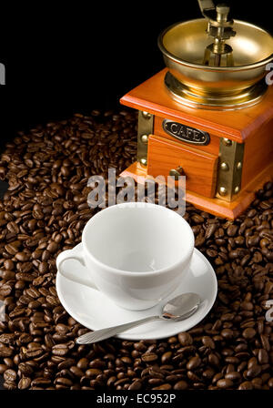 empty cup of coffee and grinder on beans Stock Photo