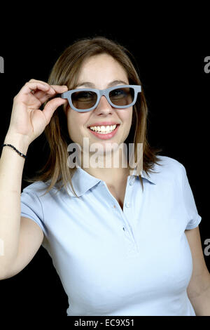pretty woman with a pair of 3d glasses on black background Stock Photo