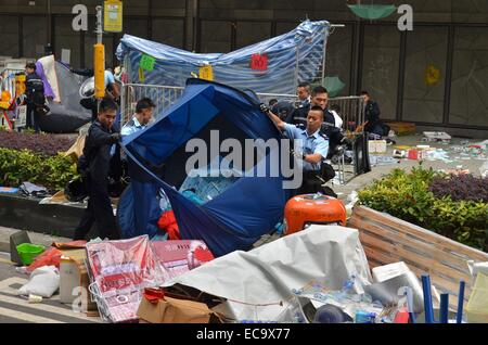 Hong Kong, China. 11th December, 2014. After 74 days of the Occupy Hong Kong protest, police enact a court injunction to remove protesters and their encampment from Connaught Road Central. The authorities had warned protesters to leave in advance of the clearance, but a few pro-democracy demonstrators remained, leading to a handful of arrests. Credit:  Stefan Irvine/Alamy Live News Stock Photo