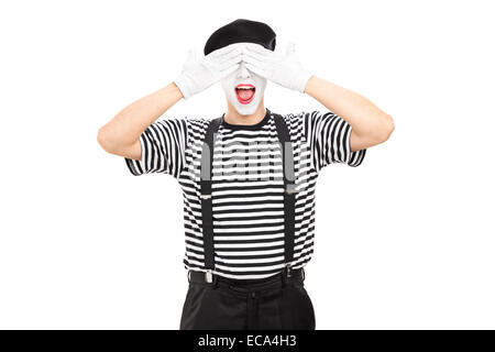 Mime artist covering his eyes isolated on white background Stock Photo
