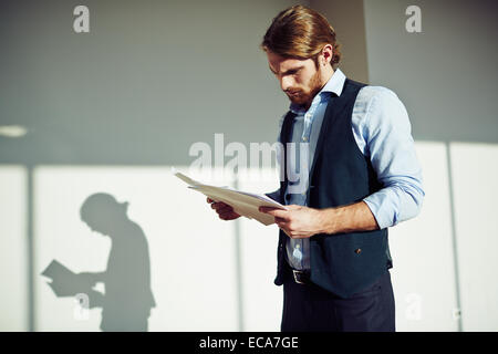 Serious businessman working with papers Stock Photo
