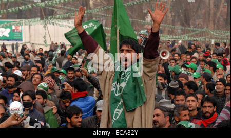 Srinagar, Kashmir. 11th December, 2014. Srinagar, supporters of December Peoples Democratic Party (PDP) charing during election campaign rally in SrinagarThe final two phases of the five-phased state elections of Jammu and Kashmir will be held on Dec. 14 and 20.and Resultson 23 December. Credit:  sofi suhail/Alamy Live News Stock Photo