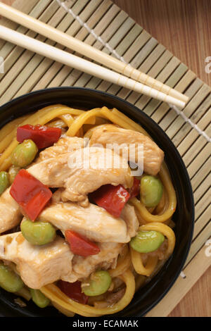 Teriyaki chicken with egg noodles edamame and red peppers Stock Photo