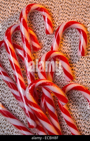 A candy cane or peppermint stick is a cane-shaped hard candy stick associated with Christmas. Stock Photo