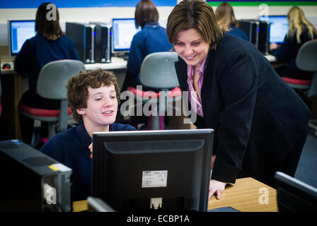 teacher helping student in coding class,UK Stock Photo