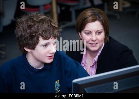 student and teacher at computer Stock Photo