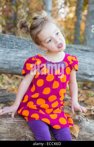 A three year old girl makes a funny face during a fall time photo session in Kalispell, Montana. Stock Photo