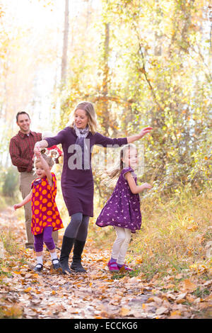 A cute family of five walk and dance during a fall time photo portrait session in Kalispell, Montana. Stock Photo