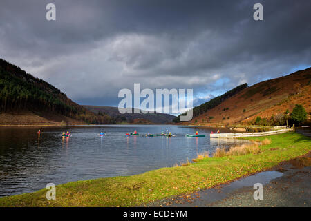 Outdoor activities young people Kayaking on at Llyn Geirionydd lake in autumn near Trefriw Snowdonia National Park Gwynedd North Stock Photo