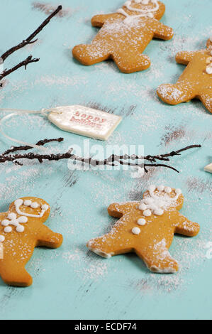 Merry Christmas festive baking concept with gingerbread cookies on vintage style recycled wood background. Closeup angle. Stock Photo