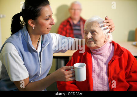 Woman, 88 years, in a nursing home, at breakfast, supported by a geriatric nurse, Stock Photo