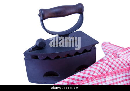 Coal iron with burning embers inside placed next to a plaid cloth isolated on white background Stock Photo