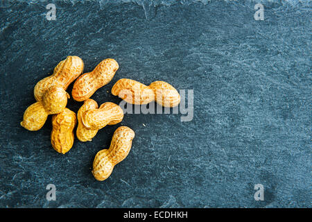 Closeup on peanuts on stone substrate Stock Photo