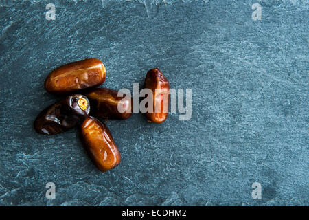 Closeup on dates on stone substrate Stock Photo