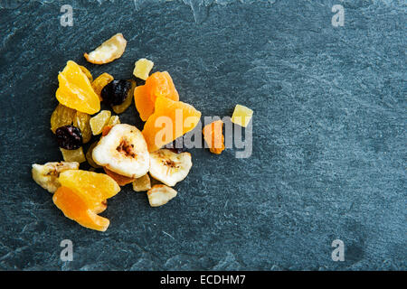 Closeup on mix of dried fruits on stone substrate Stock Photo