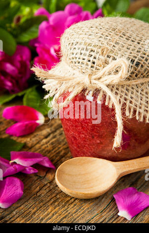 Homemade jam made from damascus petal rose on wooden table. Selective focus Stock Photo