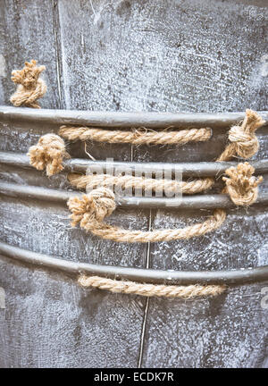 Close up of the edge of a pile of metal containers with rope handles Stock Photo