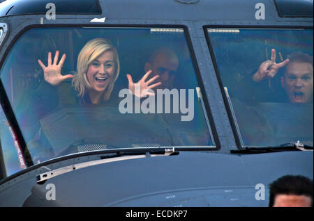 Singer Kellie Pickler and her husband, Kyle Jacobs wave from inside a CV-22 Osprey Aircraft as they arrive to perform for US service members as part of the USO holiday tour at Royal Air Force Mildenhall December 10, 2014 in Mildenhall, England. This was Pickler’s eighth USO tour. Stock Photo
