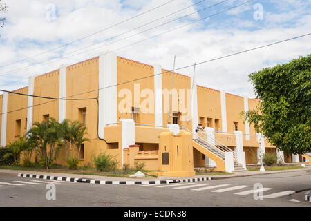 The yellow historic Moncado Barracks in Santiago de Cuba, second city of Cuba, with bullet holes in the walls from the communist revolution Stock Photo