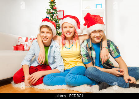 Teens kids on New year party in Santa hats Stock Photo