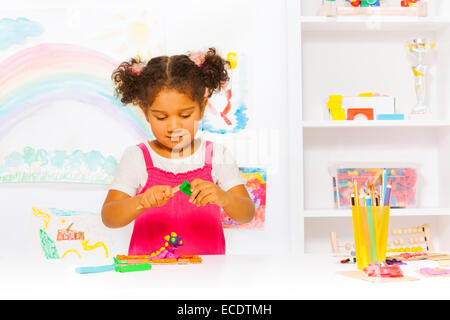 Preschool girl play with modeling clay in class Stock Photo