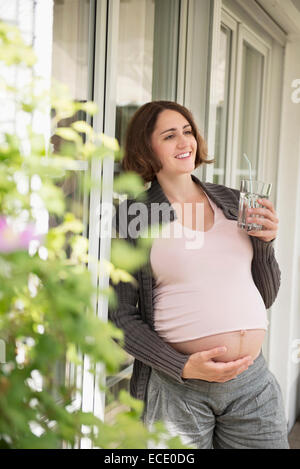 Photo of happy pregnant woman with glass of milk Stock Photo - Alamy