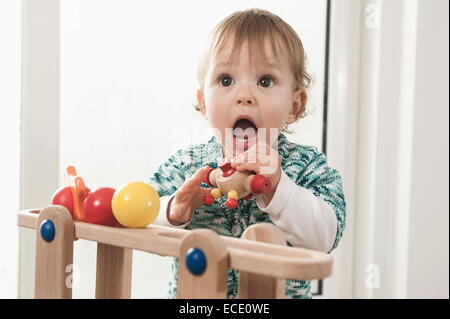 Portrait 1 year old baby girl playing toy Stock Photo