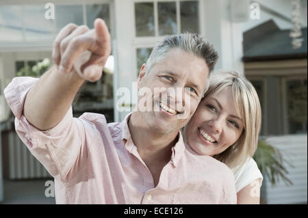 Man woman middle aged pointing garden loving happy Stock Photo