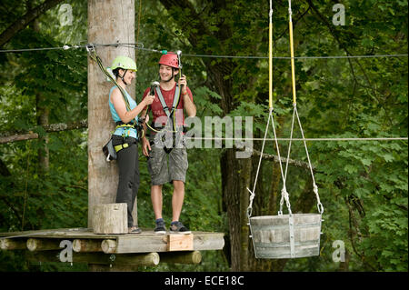 Young woman and young man climbing crab Stock Photo