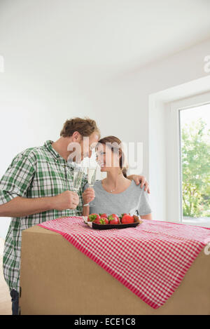 Man woman celebrating new house wine Stock Photo