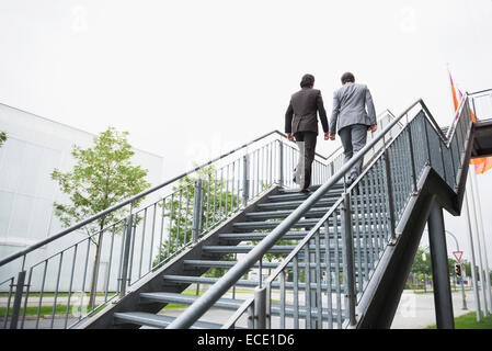 Businessmen ascent ladder of success job Teamwork Stock Photo
