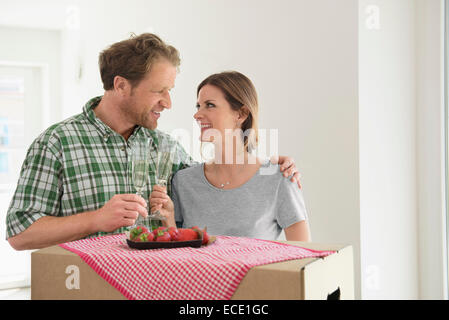 Happy couple new house celebrating drinking Stock Photo