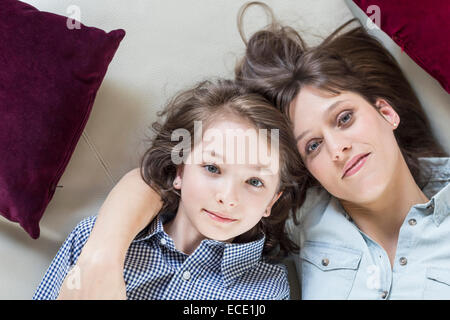 Portrait of mother and daughter lying on floor, smiling Stock Photo