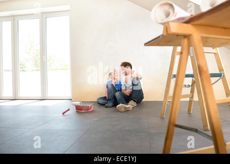 Father son working taking a break painting Stock Photo