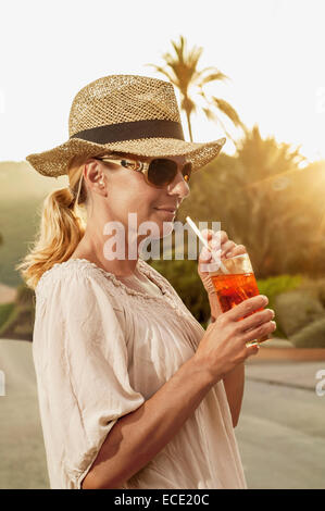 Portrait chic mature blond woman holiday cocktail Stock Photo