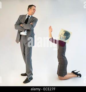 businesswoman with mask pleading to businessman Stock Photo