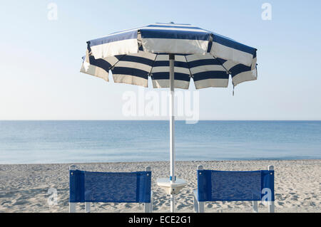 Two beach chairs umbrella ocean summer empty Stock Photo