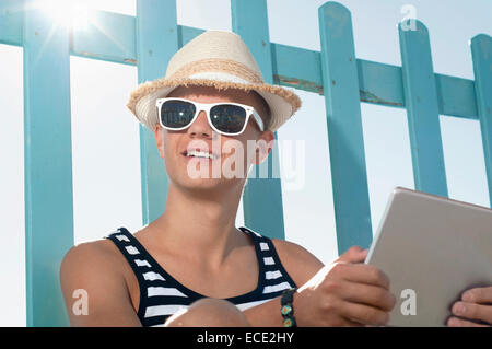 Teenage boy holiday beach summer tablet computer Stock Photo