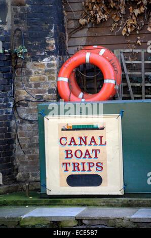 London, England, UK. Canal Boat Trips sign and lifebelts in Camden Lock Stock Photo