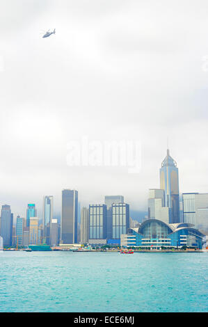 Flying helicopter in Hong Kong sky in the misty morning Stock Photo