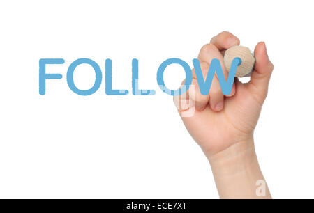 Woman hand writing with blue pencil word follow on white background Stock Photo