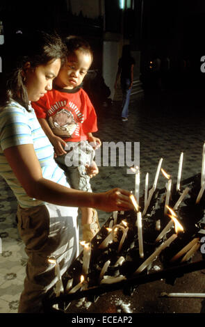 Placing candles inside the Cathedral of St. Paul. Vigan. Ilocos. Philippines. The St. Paul’s Cathedral is also known as the metr Stock Photo