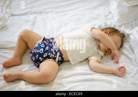 Baby boy sleeping on a bed Stock Photo